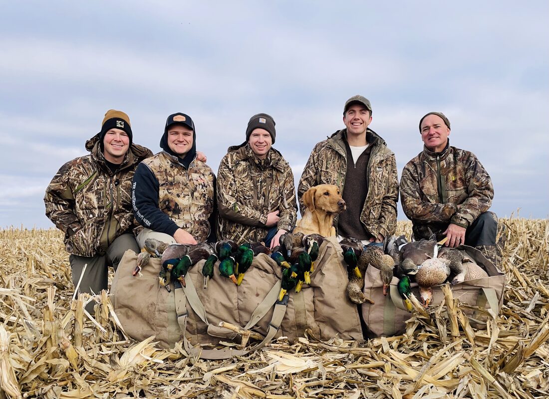 Jack Winders duck hunting in South Dakota with friends and a dog